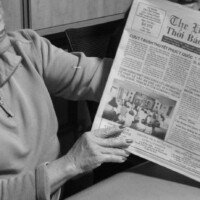 Nho Nguyen (wife) with one of many newspapers.